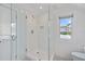 Modern bathroom featuring glass enclosed shower, white subway tile, and patterned floor at 1841 Datura St, Sarasota, FL 34239