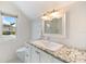 Chic bathroom with granite countertop, a white vessel sink, and modern fixtures at 1841 Datura St, Sarasota, FL 34239
