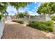 Brick driveway leading to a charming two-story home with manicured landscaping and mature trees at 1841 Datura St, Sarasota, FL 34239