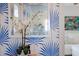 Close-up of a mirror and orchid on a table, with blue palm wallpaper in the background at 1841 Datura St, Sarasota, FL 34239