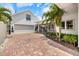 Charming home with a brick driveway, mature palm trees, and a well-maintained garden at 1841 Datura St, Sarasota, FL 34239
