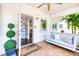Inviting front porch with a swing, stylish decor, and a glimpse of the home's interior design at 1841 Datura St, Sarasota, FL 34239