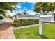 Charming two-story home with manicured landscaping, brick pathway, and mailbox showing the house number and street name at 1841 Datura St, Sarasota, FL 34239