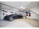 Spacious garage with epoxy floors, ample storage, and a sleek black car at 1841 Datura St, Sarasota, FL 34239