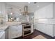 Modern kitchen with white cabinets, granite countertops, and a stainless steel oven range at 1841 Datura St, Sarasota, FL 34239