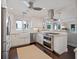 Beautiful kitchen featuring stainless steel appliances, a farmhouse sink, and a seamless flow to the living area at 1841 Datura St, Sarasota, FL 34239