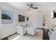 Bright living room with comfortable white seating, ceiling fan, and stylish decor at 1841 Datura St, Sarasota, FL 34239