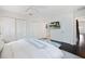 Spacious main bedroom with TV, large closet, stylish decor, and comfortable seating area at 1841 Datura St, Sarasota, FL 34239