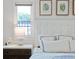 Main bedroom with decorative bedframe, modern side table, and natural light from large windows at 1841 Datura St, Sarasota, FL 34239