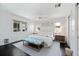 Sunlit main bedroom showcases stylish decor, upholstered bedframe, and rich dark wood floors at 1841 Datura St, Sarasota, FL 34239