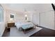 Bright main bedroom featuring a cozy upholstered bed, stylish bench and ample natural light at 1841 Datura St, Sarasota, FL 34239