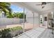 Screened patio showing decorative tile floor, and view of brick driveway and garage at 1841 Datura St, Sarasota, FL 34239