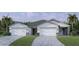 Charming two-story home with well-manicured lawn and driveway leading to a two-car garage at 18845 Dayspring Pl, Venice, FL 34293
