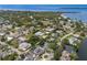 Aerial shot showing the home's location in a serene neighborhood, near to the water and surrounded by lush trees at 1904 Nw 79Th St, Bradenton, FL 34209