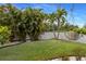 Lush green backyard with mature trees and a privacy fence, perfect for outdoor activities at 1904 Nw 79Th St, Bradenton, FL 34209