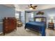 Comfortable bedroom with a blue bed, a dresser, and a cozy chair at 1904 Nw 79Th St, Bradenton, FL 34209