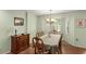Cozy dining room with a bay window, chandelier, and dark wood cabinet at 1904 Nw 79Th St, Bradenton, FL 34209