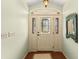 A welcoming foyer showcasing tiled flooring and a decorative glass front door at 1904 Nw 79Th St, Bradenton, FL 34209