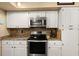 Updated kitchen featuring stainless steel appliances and white cabinetry at 1904 Nw 79Th St, Bradenton, FL 34209