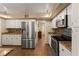 Modern kitchen with stainless steel appliances, white cabinets, and tile flooring at 1904 Nw 79Th St, Bradenton, FL 34209
