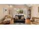 Charming living room with tile flooring, French doors and a view of the pool at 1904 Nw 79Th St, Bradenton, FL 34209
