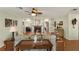 A bright and open living room featuring a fireplace, tiled floors, and a ceiling fan at 1904 Nw 79Th St, Bradenton, FL 34209