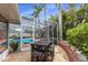 Outdoor patio boasts a modern dining table and chairs, with views of the pool area and lush landscaping at 1904 Nw 79Th St, Bradenton, FL 34209