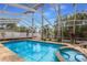 Relaxing screened-in pool with an attached spa, surrounded by lush landscaping and palm trees at 1904 Nw 79Th St, Bradenton, FL 34209