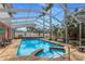 Relaxing screened-in pool with an attached spa, surrounded by lush landscaping and palm trees at 1904 Nw 79Th St, Bradenton, FL 34209