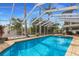 Relaxing screened-in pool with an attached spa, surrounded by lush landscaping and palm trees at 1904 Nw 79Th St, Bradenton, FL 34209