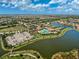 An aerial view highlighting the community pool, lake access, and tennis courts at 20542 Trattoria Loop, Venice, FL 34293