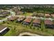 An aerial view of a residential area with houses with screened-in pools and tile roofs in a planned community at 20542 Trattoria Loop, Venice, FL 34293