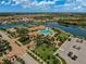 A scenic aerial view of the community showcasing the pool, clubhouse, and access to the lake at 20542 Trattoria Loop, Venice, FL 34293