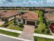 Community aerial view featuring a home with a red tile roof and paver driveway at 20542 Trattoria Loop, Venice, FL 34293