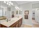 Bright bathroom with double sinks, warm color palette, and large walk in shower at 20542 Trattoria Loop, Venice, FL 34293