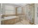 Elegant bathroom with a soaking tub and large glass enclosed shower at 20542 Trattoria Loop, Venice, FL 34293