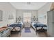 Charming bedroom featuring two twin beds with nautical themed decor and a ceiling fan at 20542 Trattoria Loop, Venice, FL 34293