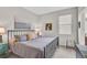 Cozy bedroom with a metal frame bed, soft gray tones, and minimalist decor at 20542 Trattoria Loop, Venice, FL 34293