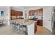 Spacious kitchen with a granite island, stainless steel appliances, and a breakfast bar at 20542 Trattoria Loop, Venice, FL 34293