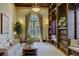 A beautiful living room showcases built-in bookcases and a large arch window providing plenty of natural light at 20542 Trattoria Loop, Venice, FL 34293