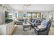 Comfortable living room with bright natural light and view to the pool and outdoor living area at 20542 Trattoria Loop, Venice, FL 34293