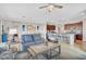Bright living room flowing into a kitchen with granite counters and seating at the breakfast bar at 20542 Trattoria Loop, Venice, FL 34293