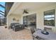 Inviting covered patio with comfortable seating and a view of the dining room interior at 20542 Trattoria Loop, Venice, FL 34293