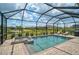 Outdoor pool and spa area with a screened enclosure overlooking lush landscaping at 20542 Trattoria Loop, Venice, FL 34293