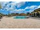 A gorgeous pool with brick floors and lounge chairs beneath a partly cloudy blue sky at 20542 Trattoria Loop, Venice, FL 34293