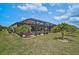 Beautiful backyard view of pool with screened enclosure, and lush tropical landscaping at 20542 Trattoria Loop, Venice, FL 34293