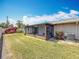 Enjoy a screened lanai, lush lawn, and landscaped yard in this charming home's backyard at 2188 Corinne S Ct # A, St Petersburg, FL 33712