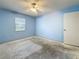 Bedroom featuring blue walls, a ceiling fan, a window, and a door at 2188 Corinne S Ct # A, St Petersburg, FL 33712