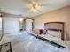 Bedroom featuring beige walls, a ceiling fan, an en-suite bathroom, and a closet at 2188 Corinne S Ct # A, St Petersburg, FL 33712