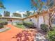 Exterior home view, featuring front door, manicured bushes, and landscaped walkway at 2188 Corinne S Ct # A, St Petersburg, FL 33712